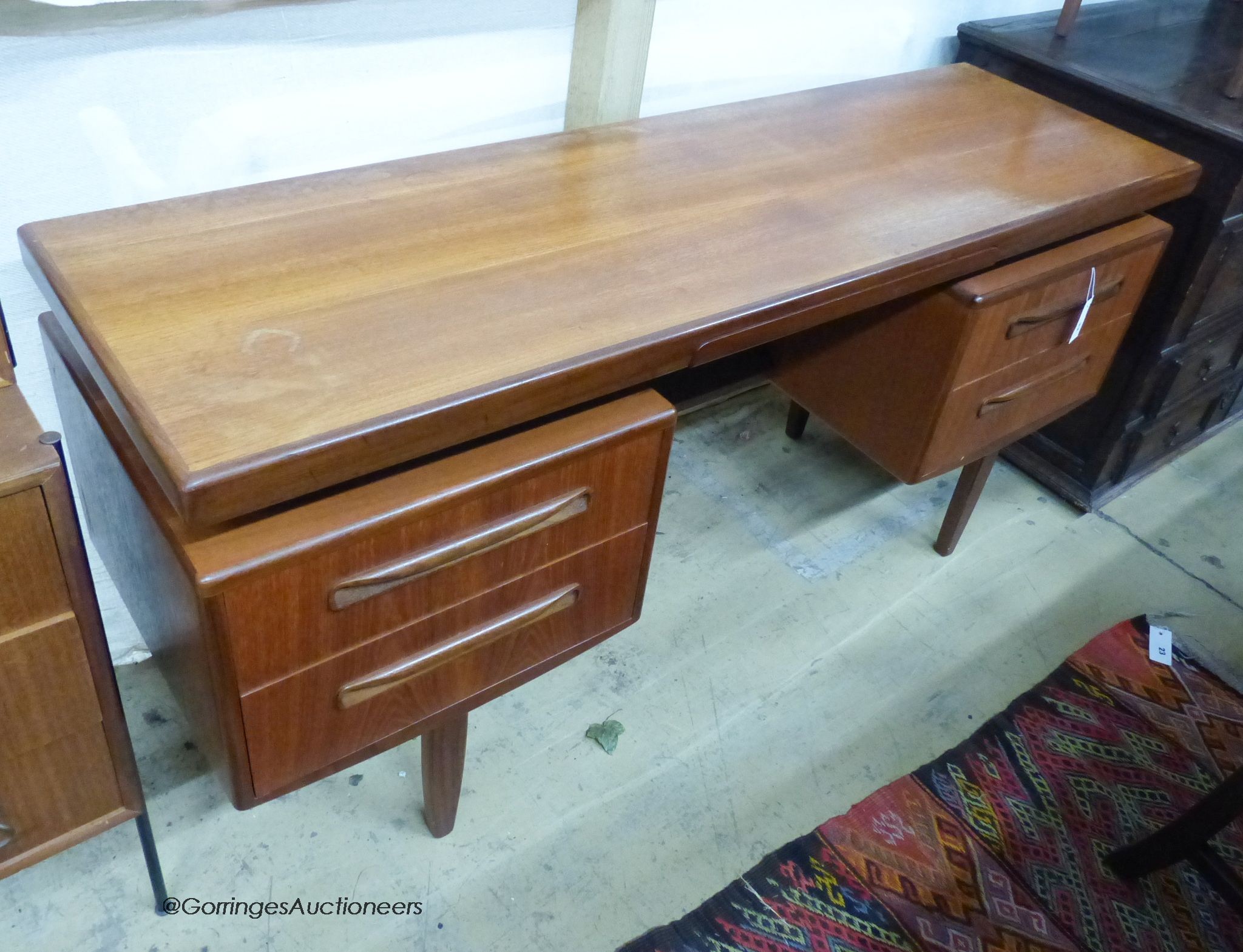 A mid century design G plan teak dressing table, length 152cm, depth 46cm, height 70cm